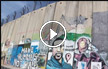 فنانون يخطون بريشتهم رسومات على الجدار الفاصل قرب القدس